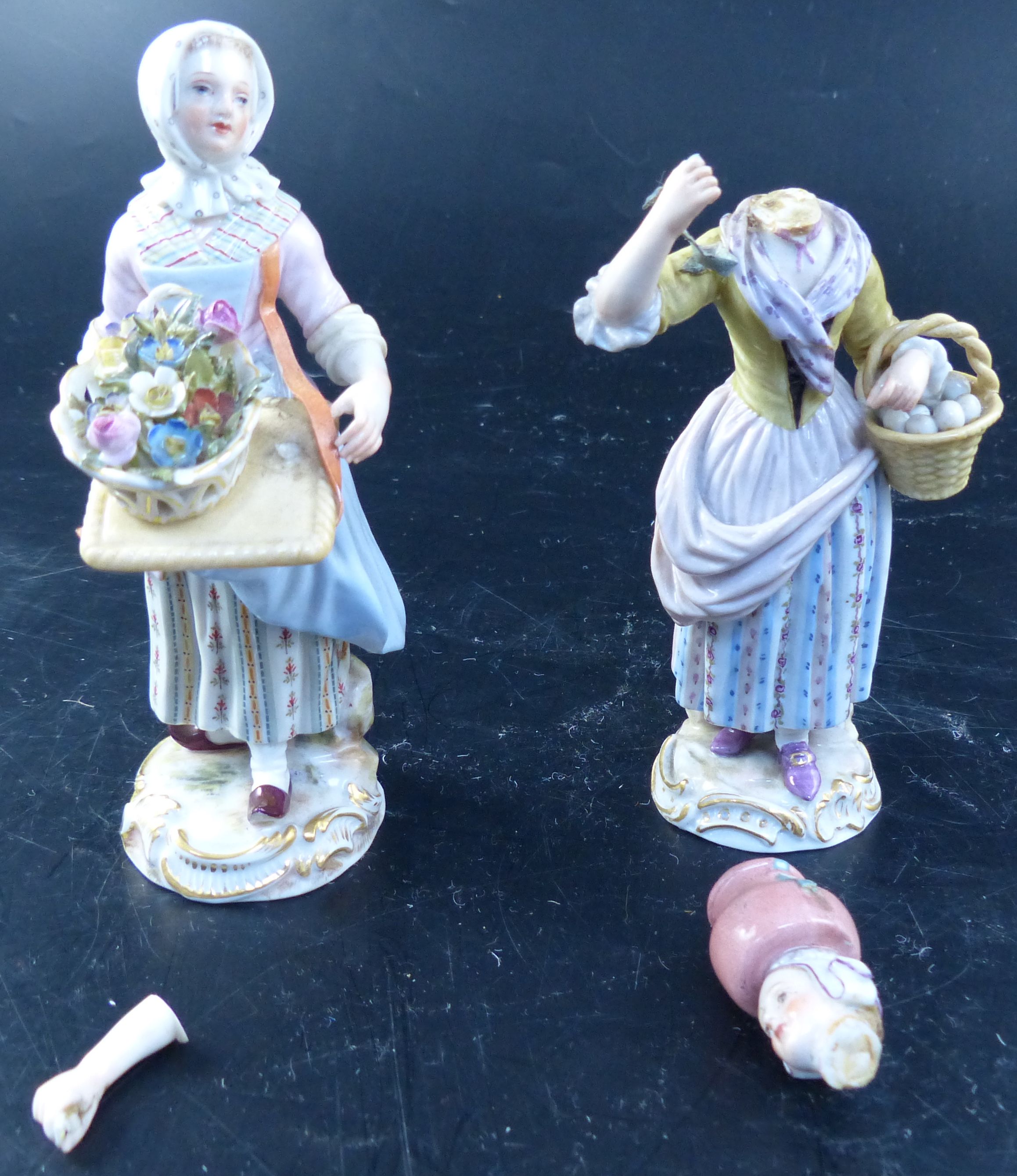 A pair of early 20th century Meissen figures of street vendors, 14cm (a.f.)